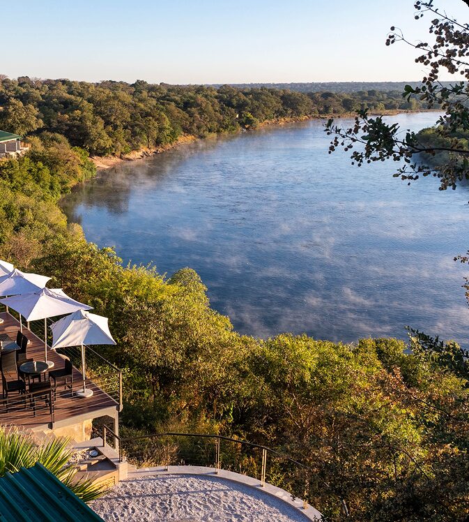 Simanya's riverside deck and umbrellas above the Kavango River