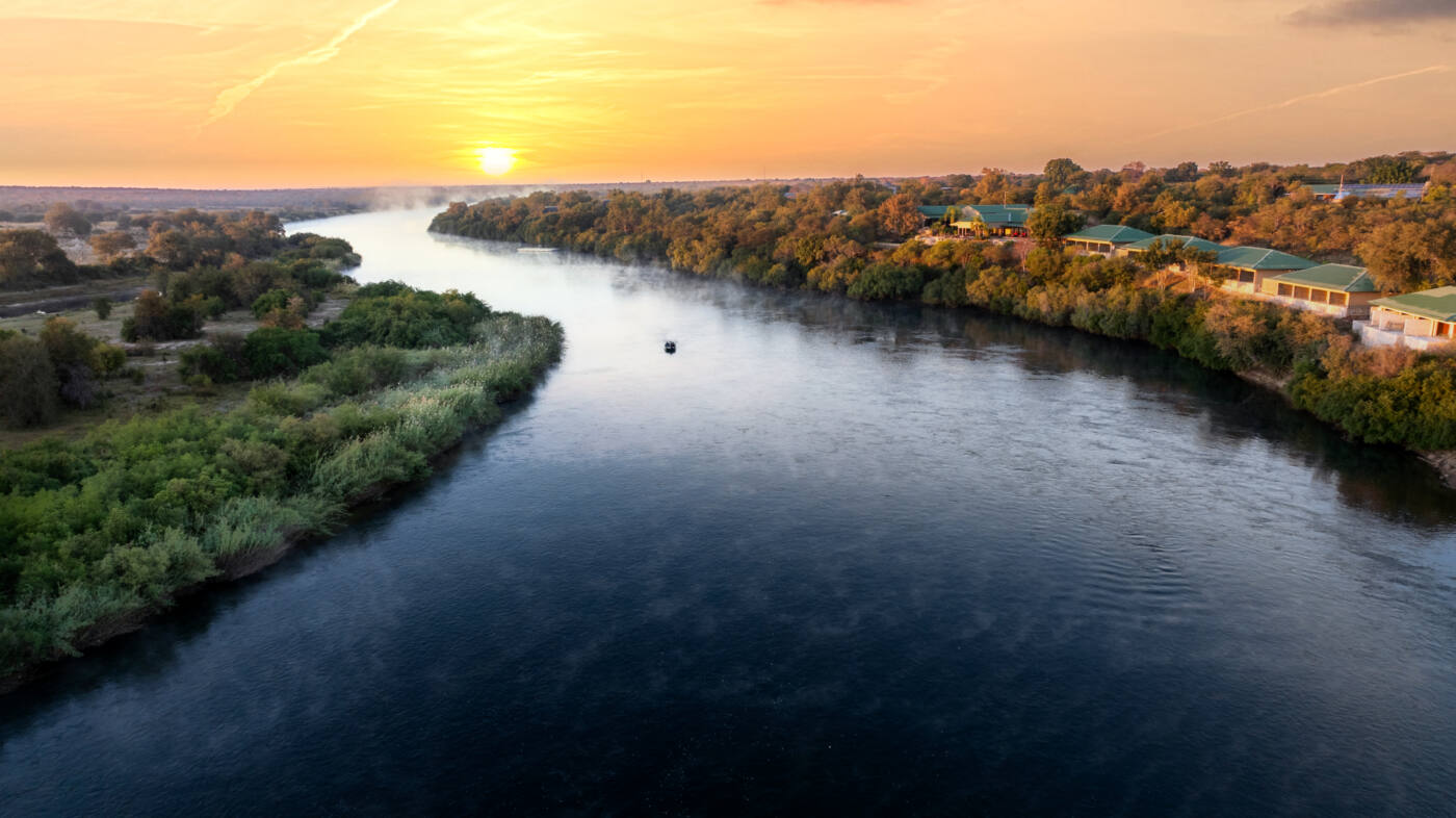 The Kavango River winding through riverine forest near Simanya River Lodge
