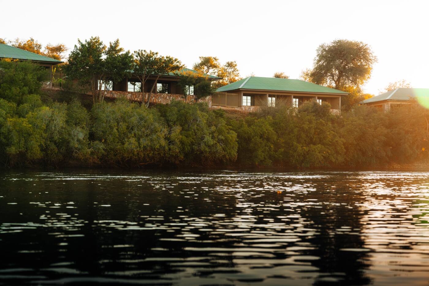 Simanya River Lodge on the riverbank at sunset